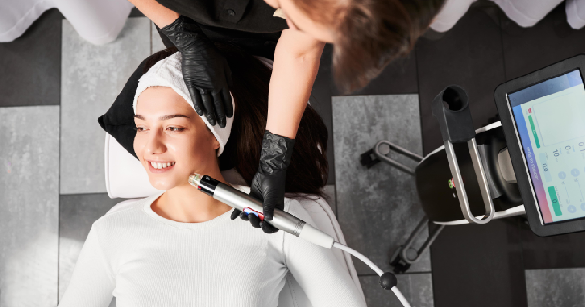 A woman receiving a facial treatment with a modern RF microneedling device in Palm Springs, CA
